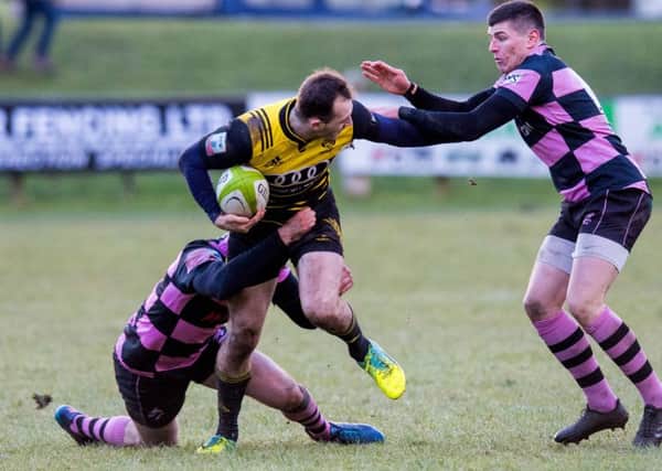 Melrose's Nyle Godsmark is tackled by Ayr's Stafford McDowall and Scott Lyle. Picture: Ross Parker/SNS