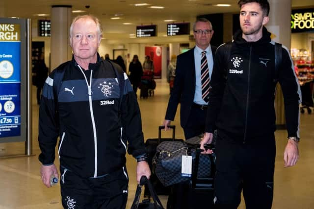 Jimmy Nicholl, left, walks through Edinburgh Airport with new signing Sean Goss en route to Florida on Saturday. Picture: SNS.