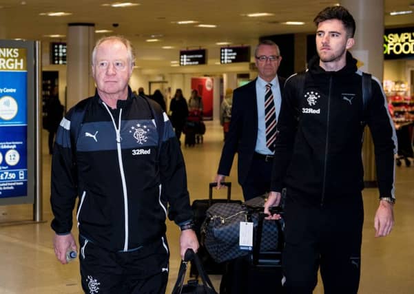 Jimmy Nicholl, left, walks through Edinburgh Airport with new signing Sean Goss en route to Florida on Saturday. Picture: SNS.