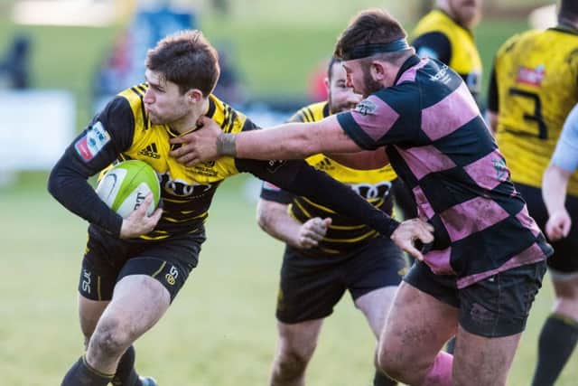 Melrose stand-off Jason Baggot, left, tries to shake off a tackle during the Borderers' defeat by Ayr at The Greenyards on Saturday.