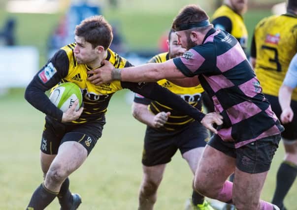 Melrose stand-off Jason Baggot, left, tries to shake off a tackle during the Borderers' defeat by Ayr at The Greenyards on Saturday.