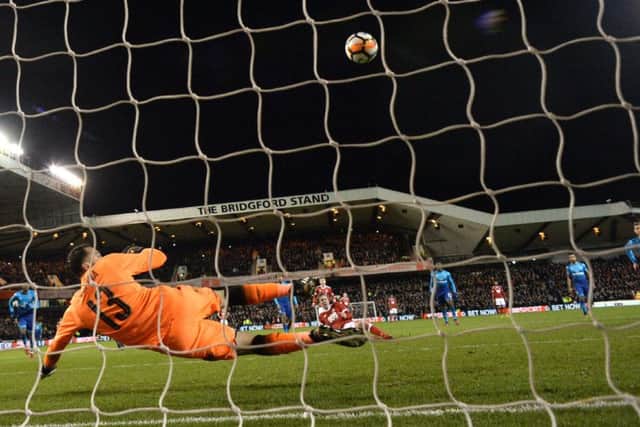 Kieran Dowall slips at the last moment, but still finds the net with his penalty to seal Forests victory. Picture: AFP/Getty.