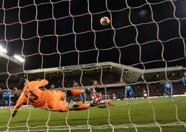 Kieran Dowall slips at the last moment, but still finds the net with his penalty to seal Forests victory. Picture: AFP/Getty.