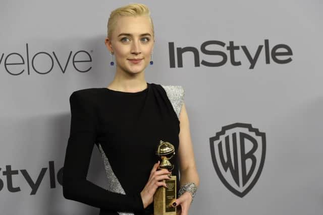 Saoirse Ronan poses with the award for best performance by an actress in a motion picture - musical or comedy for Lady Bird (Photo by Chris Pizzello/Invision/AP)