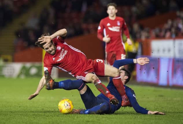 Hearts' Kyle Lafferty was sent off for this challenge on Aberdeen's Graeme Shinnie. Pic: SNS