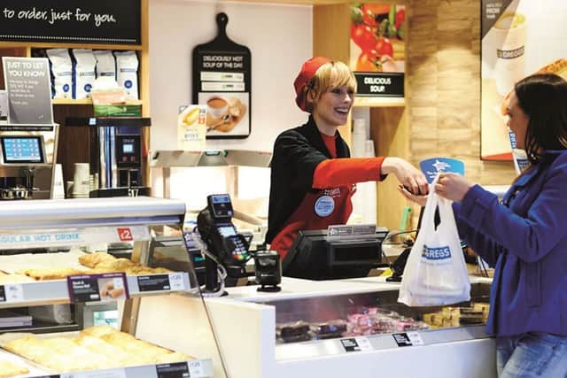 Greggs Customer service image woman serving woman at till customer with bag