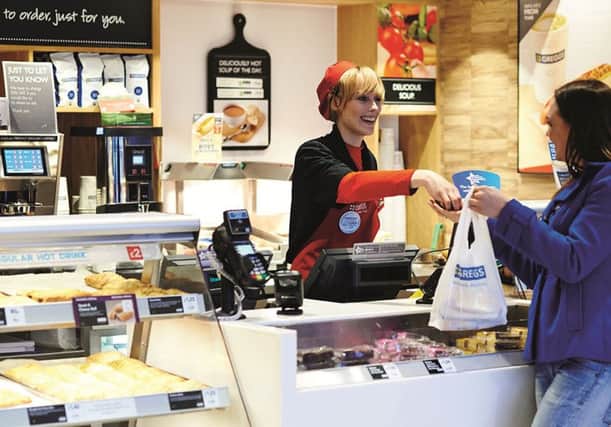 Greggs Customer service image woman serving woman at till customer with bag