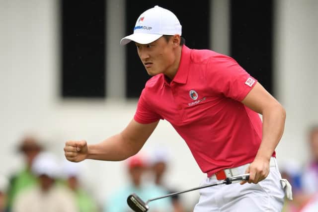 Haotong Li celebrates making a last-hole birdie to give Team Asia a 3.5-2.5 lead after the opening session in Malaysia. Picture: Getty Images