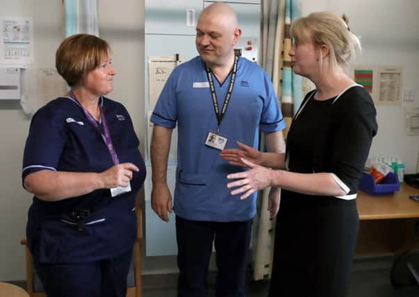 Health Secretary Shona Robison chats with Head of Nursing Brendan Forman and Senior Charge Nurse Diane Gardiner whilst visiting Perth Royal Infirmary . Picture; PA