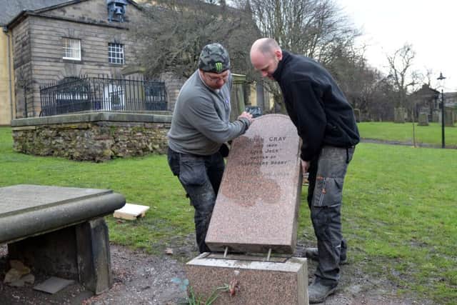 Stone Masons from William Purves funeral directors position the headstone of Bobby's master. Picture Jon Savage.