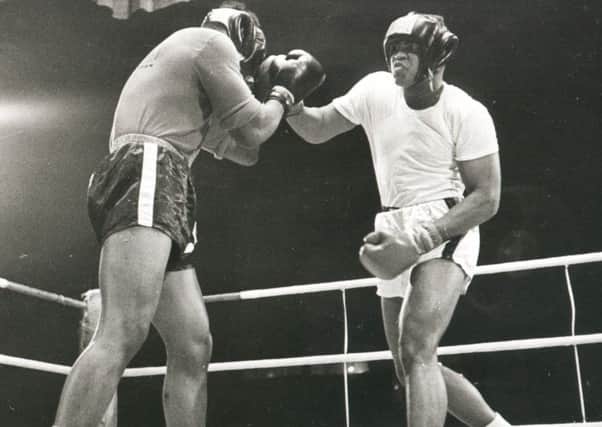 Cassius Clay (later Muhammad Ali) takes part in an exhibition bout at Paisley Ice Rink in August, 1965, with Jimmy Ellis.