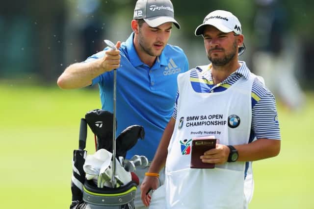 Scotland's Bradley Neil selects a club with his caddie on day two of the BMW South African Open. Picture: Warren Little/Getty Images