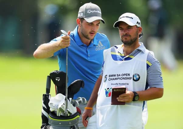 Scotland's Bradley Neil selects a club with his caddie on day two of the BMW South African Open. Picture: Warren Little/Getty Images