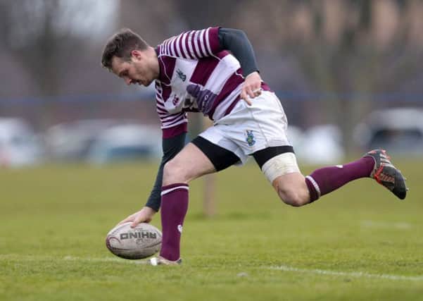 Rory Hutton touches down to put Watsonians ahead during a topsy-turvey first half yesterday. Photograph: Graham Stuart/SNS