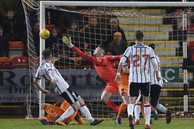 Dundee United keeper Harry Lewis is beaten but Declan McManus shot hit the post. Photograph: Rob Casey/SNS