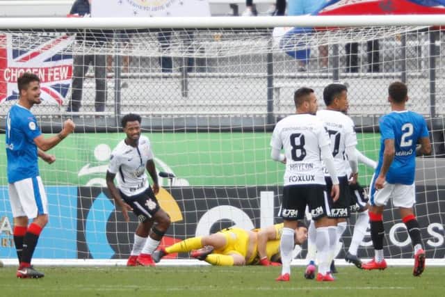 Alfredo Morelos, left, turns aways after scoring for Rangers during their second-half blitz of Brazilian champions Corinthians. Picture: AFP/Getty.