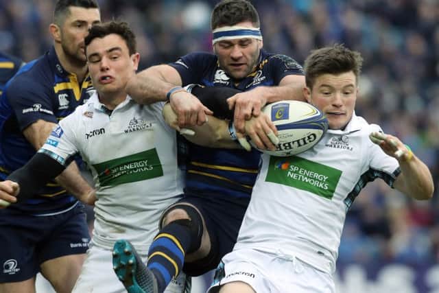 Glasgow Warriors' Lee Jones and George Horne tackle Leinsters' Fergus McFadden during the Champions Cup pool three match at The RDS Arena, Dublin. Picture: Lorraine O'Sullivan/PA Wire