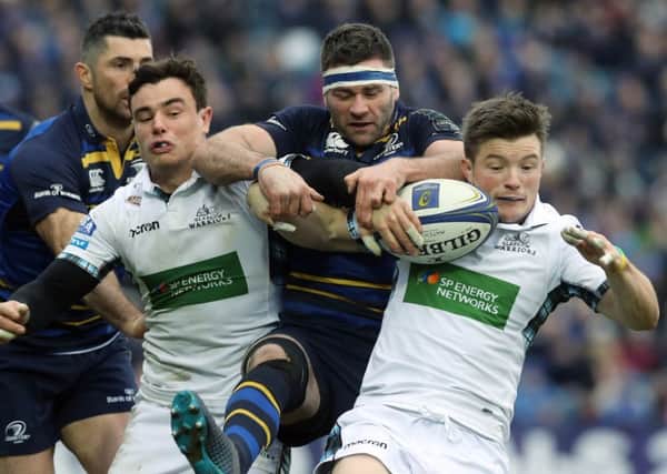 Glasgow Warriors' Lee Jones and George Horne tackle Leinsters' Fergus McFadden during the Champions Cup pool three match at The RDS Arena, Dublin. Picture: Lorraine O'Sullivan/PA Wire