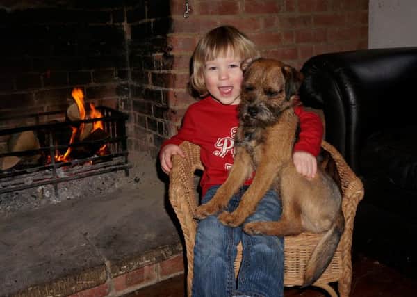 Morse the dog is now back home safe with his owner Richard Latter and son Edward, 3. Picture: SWNS