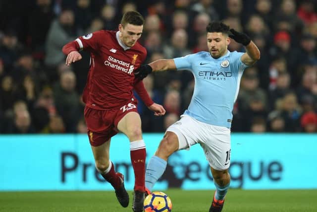 Andy Robertson challenges Manchester City forward Sergio Aguero. Picture:s AFP/Getty Images