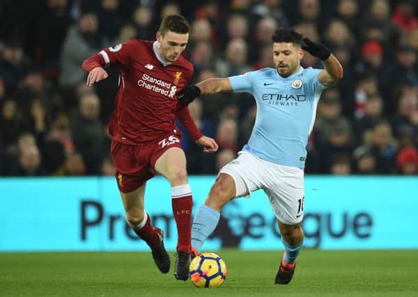 Andy Robertson challenges Manchester City forward Sergio Aguero. Picture:s AFP/Getty Images