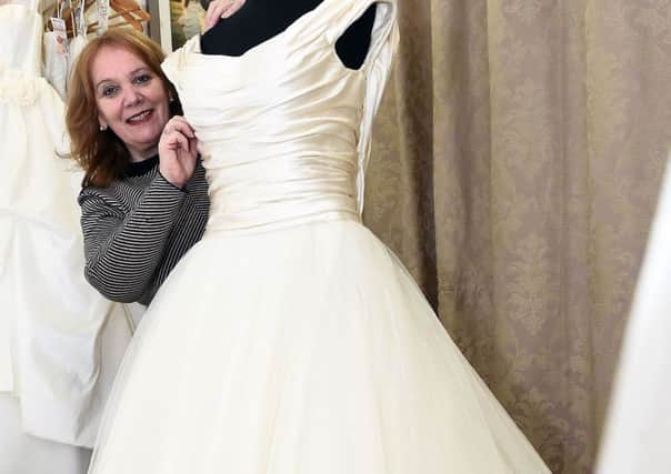 Rosa Rosado, manager of the British Red Cross charity shop in Stockbridge, Edinburgh, with a Phillipa Lepley couture wedding dress worth Â£14,000 which will be auctioned on 18 Jan 2018 at the Royal College of Physicians of Edinburgh.
PICTURE: Lisa Ferguson