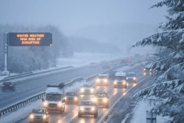 Motorists travel through a heavy snow shower on the M8. Snow and sleet conditions are affecting large parts of Scotland with long delays affecting motorists on many roads including the M8 and M74.  Picture: Getty