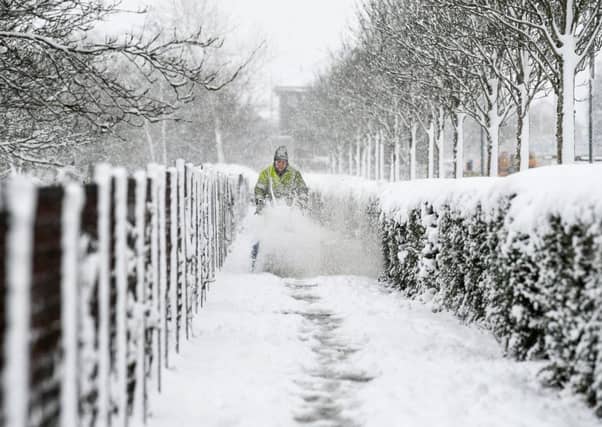 A council worker clears snow from the pavements. Picture: Getty
