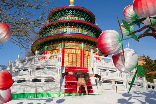 Kilted Yoga star Finlay Wilson limbers up for Burns Night at the Giant Lanterns of China display at Edinburgh Zoo. PIC: Contributed.