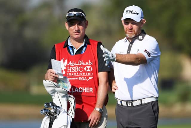 Stephen Gallacher talks through a shot with his new caddie, fellow Scot John Dempster, in the first round of the Abu Dhabi HSBC Championship. Picture: Getty Images