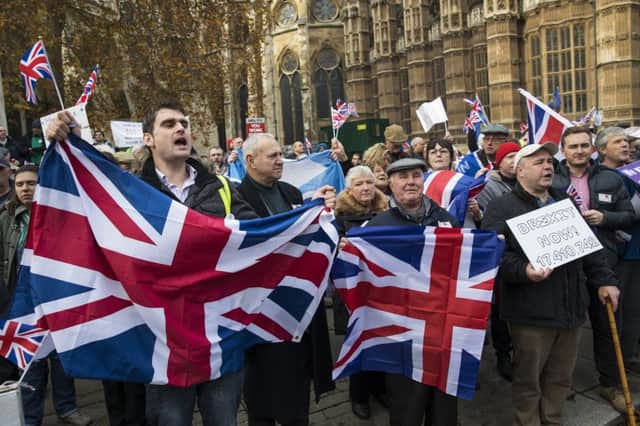 Pro-Brexit demonstrators hold Union Jack flags as they protest outside the Houses of Parliament. Picture: Jack Taylor/Getty Images