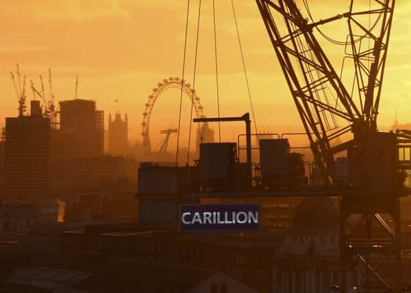 The sun sets on a Carillion construction crane in London. Photograph: AFP/Daniel Sorabji/Getty