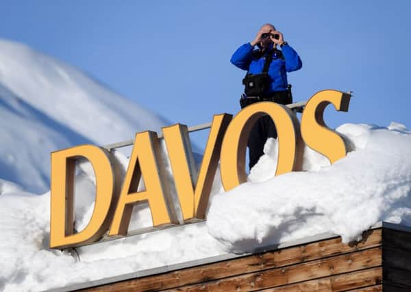A Swiss armed security guard on duty in Davos, where Theresa May is due to give a speech. Picture: AFP/Fabrice Coffrini/Getty Images