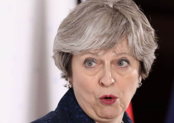 Theresa May has spoken about taking a standing over EU migrants to the UK in the Brexit transition period (Picture: AFP/Getty)