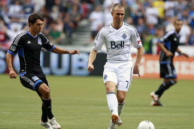 Kenny Miller of Vancouver Whitecaps holds off Shea Salinas of San Jose Earthquakes during an MLS clash in July 2012. Picture: Getty Images