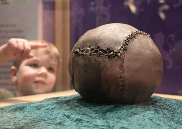 Cullen McDonald, 3, from Larbert, looks at the world's oldest football on display at the Smith Art Gallery and Museum in Stirling, Picture: Mike Day/Saltire News and Sport