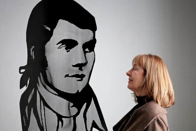 Burns Unbroke curator Sheilagh Tennant takes a closer look at a portrait of Robert Burns made from steel mesh by artist David Begbie PIC: Jane Barlow/PA Wire