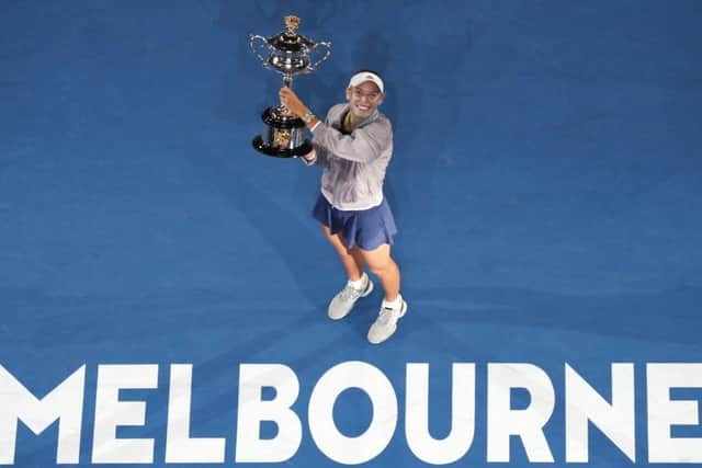Denmark's Caroline Wozniacki holds her trophy after defeating Romania's Simona Halep in the women's singles final at the Australian Open tennis championships in Melbourne. Picture: AP Photo/Ng Han Guan