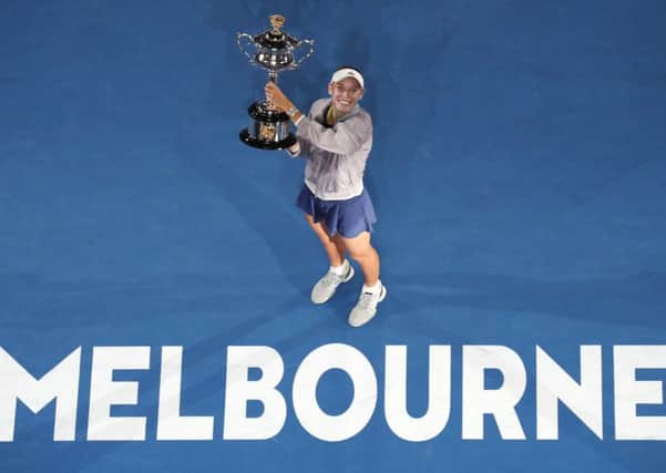 Denmark's Caroline Wozniacki holds her trophy after defeating Romania's Simona Halep in the women's singles final at the Australian Open tennis championships in Melbourne. Picture: AP Photo/Ng Han Guan