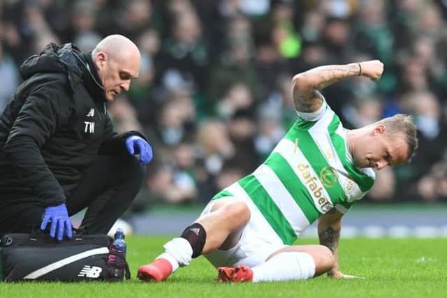 Leigh Griffiths beats the turf in frustration after suffering a calf strain minutes after scoring Celtics winner on Saturday. Picture: SNS.
