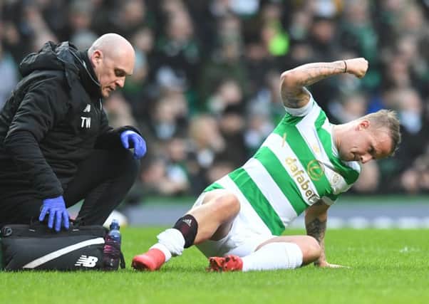 Leigh Griffiths beats the turf in frustration after suffering a calf strain minutes after scoring Celtics winner on Saturday. Picture: SNS.