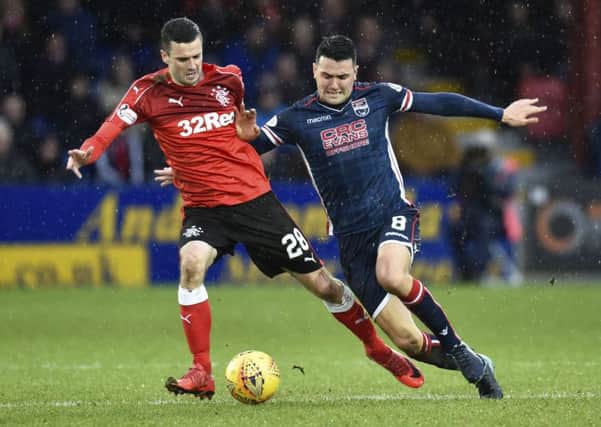 Jamie Murphy battles for possession with Ross County's Tim Chow. Picture: SNS