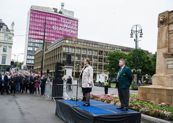 People gather for an informal vigil for victims of Manchester bomb attack in  George Square to enable Glaswegians to show support and pay their respects