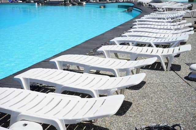Sun loungers by a pool. Picture: Creative Commons.