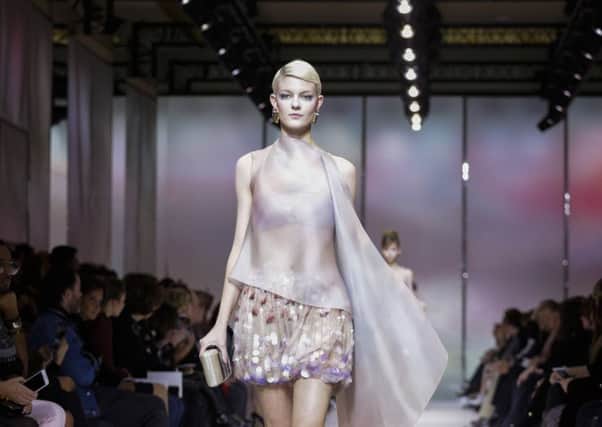 A model presents haute couture designs for Armani PrivÃ© in Paris. Picture: Valerio Mezzanotti/The New York Times