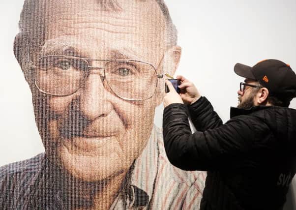 A visitor takes a photo of Ikea founder Ingvar Kamprad, at the IKEA museum in Almhult, Sweden. Picture: Ola Torkelsson/TT via AP