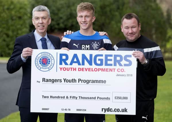 Colin Stewart, the Rangers Youth Development Company director of operations, Rangers' Ross McCrorie and Craig Mulholland,  Rangers Head of Academy with a cheque for Â£250.000.  Picture: Ross Brownlee/SNS