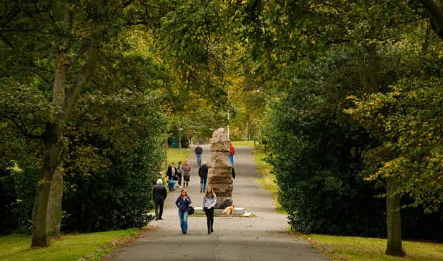 Autumn walkers in Inverleith Park in Edinburgh