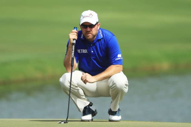 Richie Ramsay lines up a putt on the 18th green during the final round of the Omega Dubai Desert Classic.