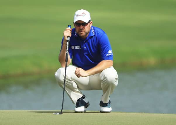 Richie Ramsay lines up a putt on the 18th green during the final round of the Omega Dubai Desert Classic.